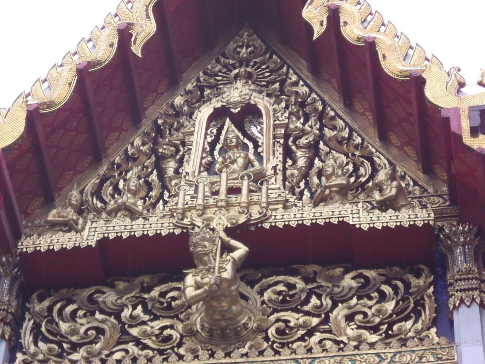 Carved and gilded gable (na ban) of Wat Ratchaburana, Bangkok, its triangle filled with kranok.