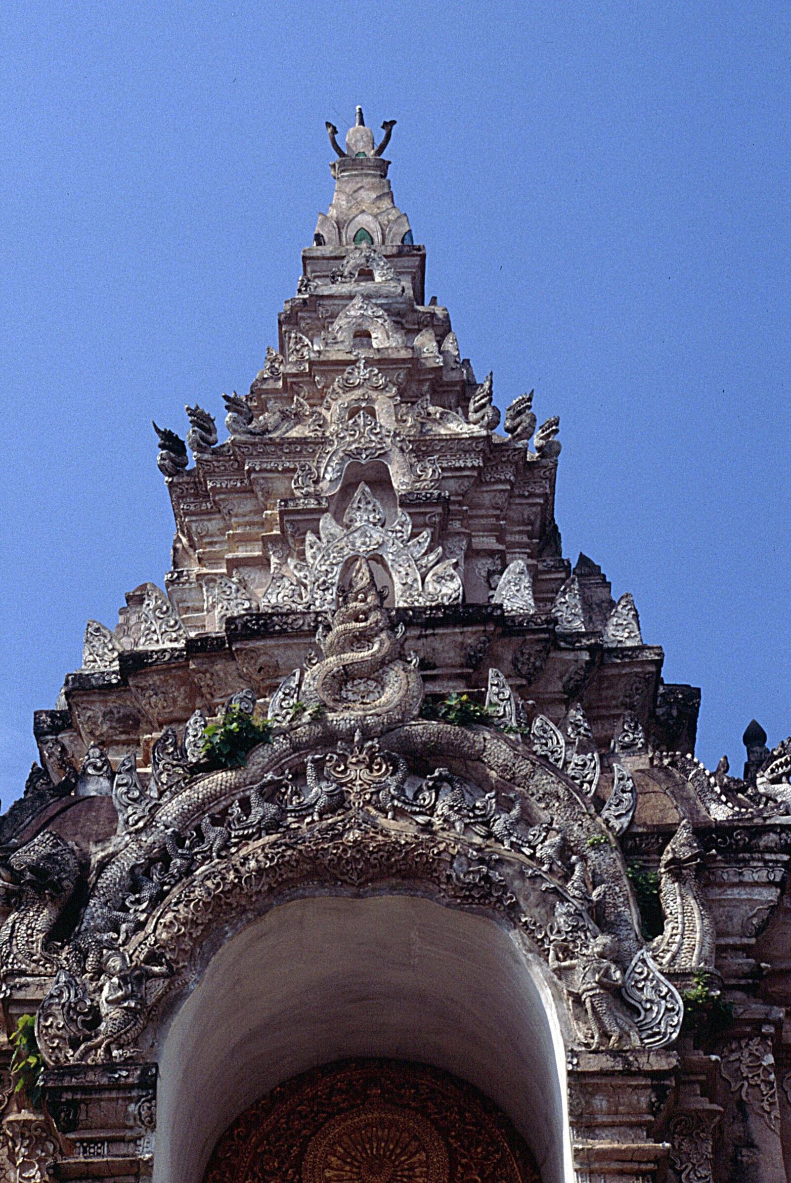 Lanna stucco: the gateway of Wat Phra That Lampang Luang, layered with kranok and flame ornament.