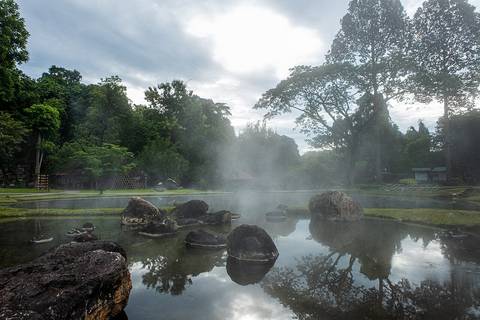 Steam rising from a natural hot spring pond at Chae Son National Park, Lampang, Thailand.
