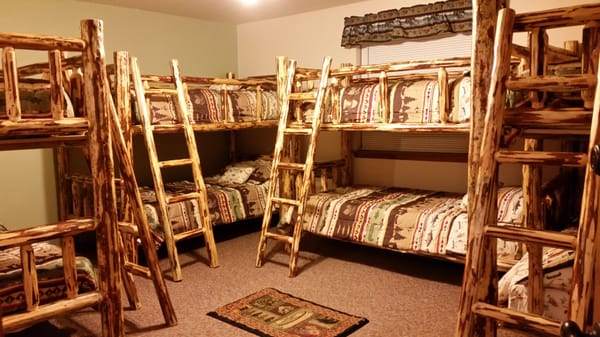 The PCT bunk room: log bunk beds with patterned quilts