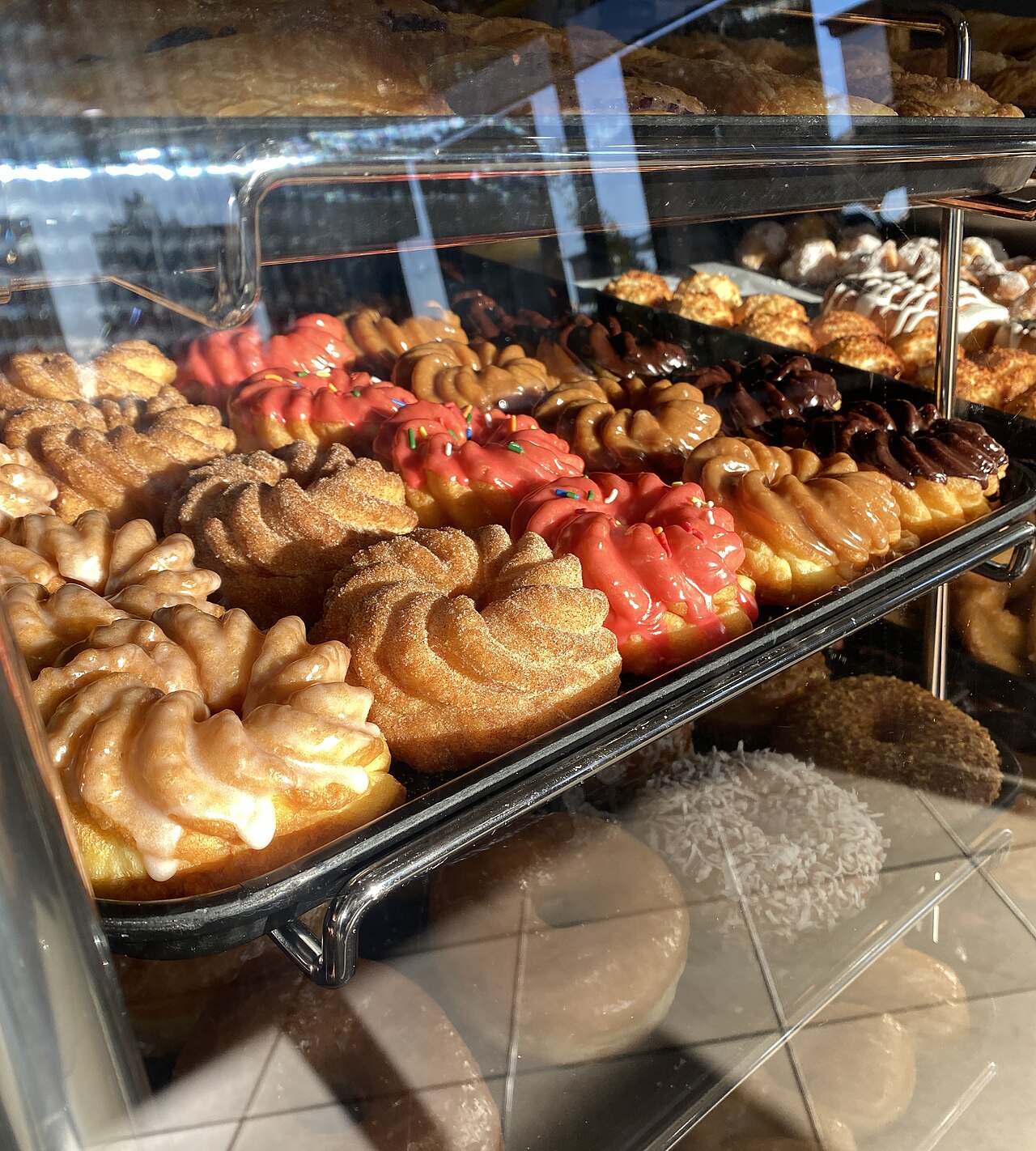 French crullers in a doughnut shop display case in California 2023 Jan