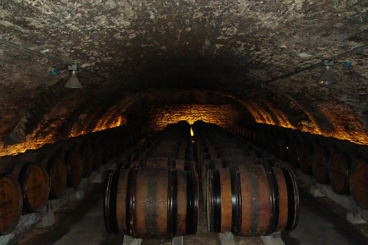 Wine cave containing aging oak barrels of wine in the French region of Burgundy
