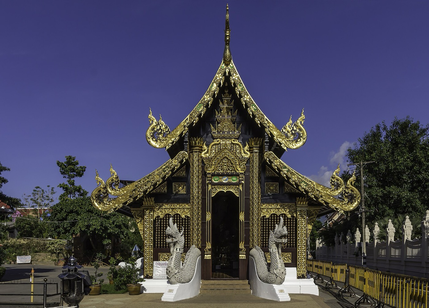 A gilded Lanna shrine with naga balustrades at Wat Inthakhin Sadue Mueang